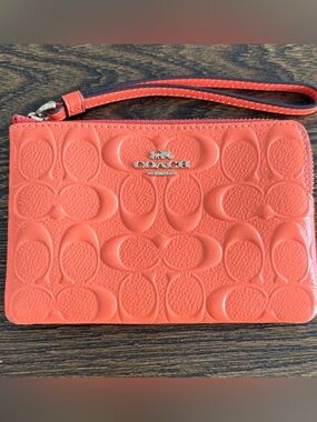 Like NEW Coach Coral Embossed Signature Wristlet with Silver Logo
